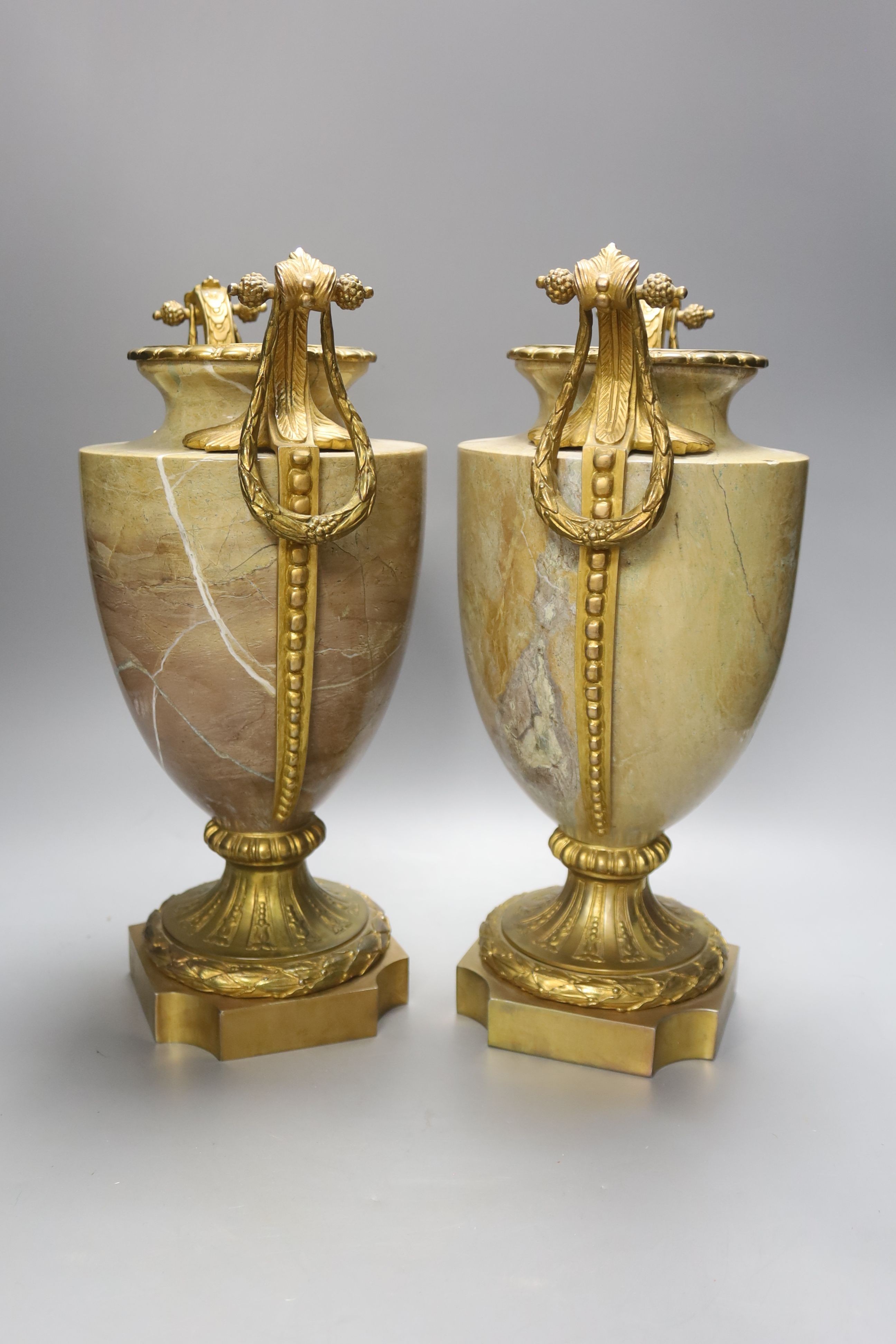 A pair of gilt metal and marble urns, overall height 34cm